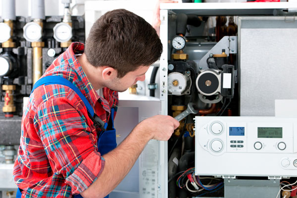 HVAC technician inspecting an indoor heating system in Scottsdale, AZ